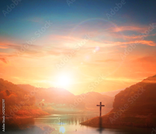 Easter concept:Silhouette cross on Calvary mountain sunset background. 