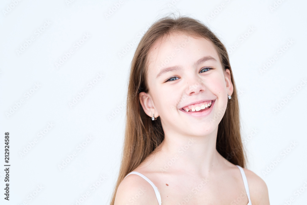 emotion face. joyful beautiful child with a wide smile. little girl portrait on white background. mood feelings personality and facial expression concept emotion face. joyful beautiful child with a wide smile. little girl portrait on white background. mood feelings personality and facial expression concept