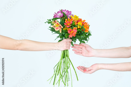 alstroemeria bouquet. spring or summer floral arranging. beautiful present. hands handing over a flower gift