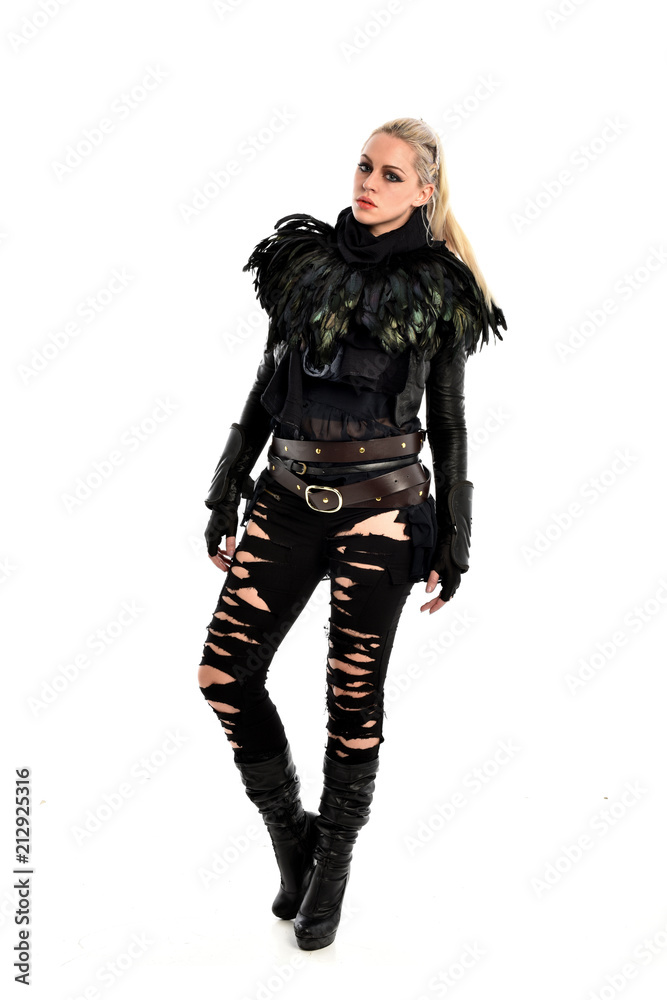full length portrait of blonde girl wearing torn black feather costume. standing pose, isolated on white background. full length portrait of blonde girl wearing torn black feather costume. standing pose, isolated on white background.