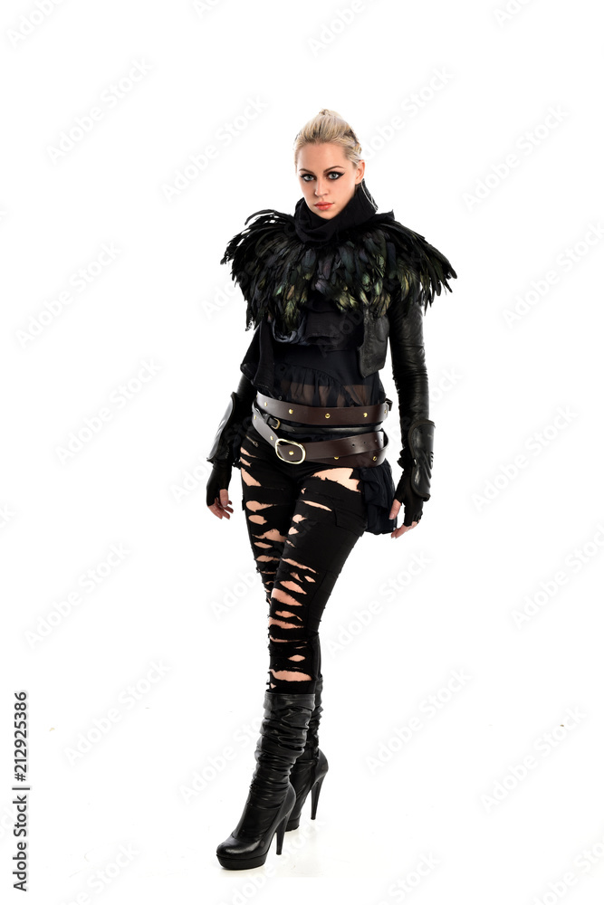 full length portrait of blonde girl wearing torn black feather costume. standing pose, isolated on white background. full length portrait of blonde girl wearing torn black feather costume. standing pose, isolated on white background.