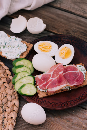 Italian style lunch jamon snack decorated with boiled eggs and cucumbers.