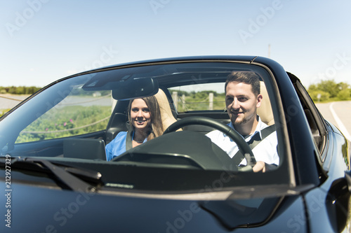 Couple enjoying a drive in a convertible