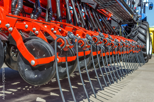 Mechanisms for the tractor are used for cultivating the land and planting seeds. Mechanization of agriculture.