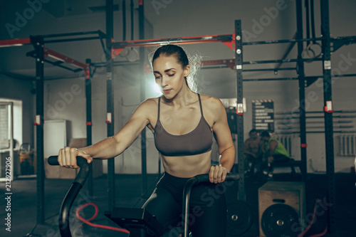 woman during exercises in the fitness gym. CrossFit.