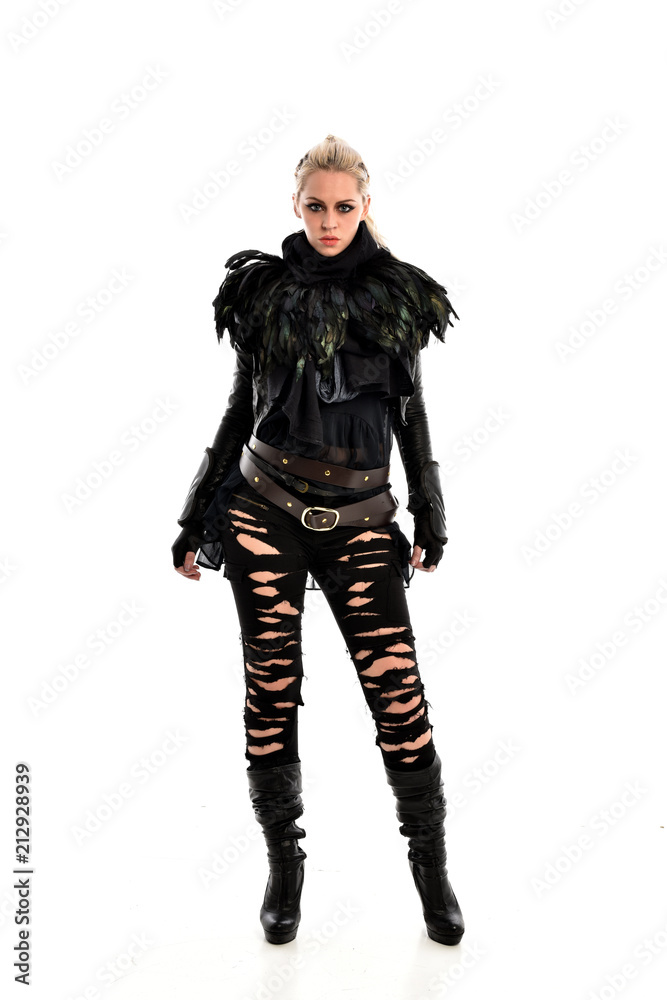 full length portrait of blonde girl wearing torn black feather costume. standing pose, isolated on white background.