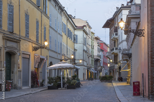 PARMA, ITALY - APRIL 18, 2018: The street of the old town at dusk.