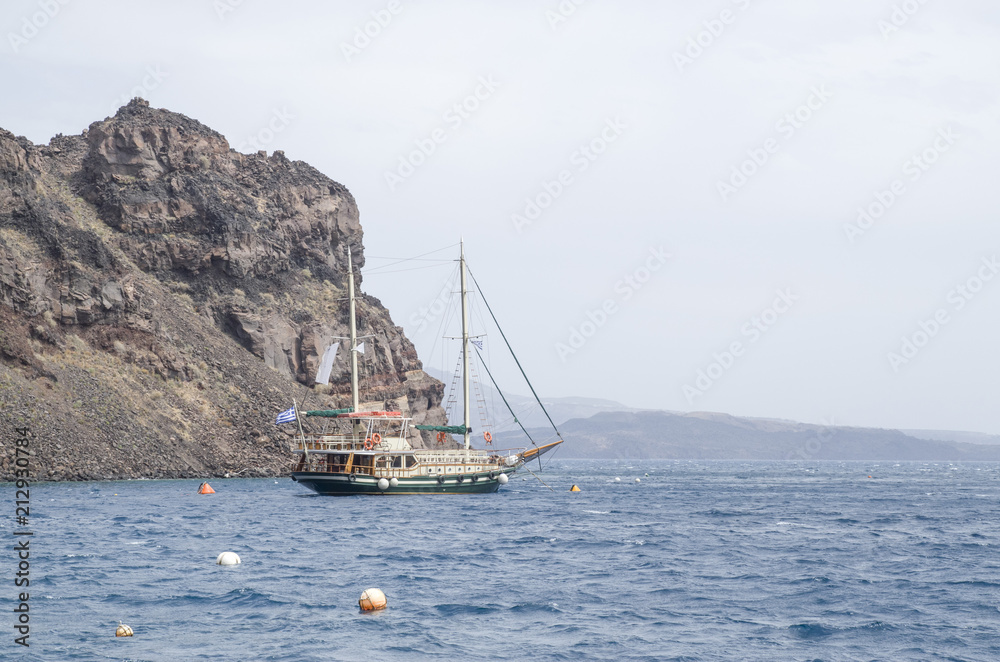 Wooden ship for trip near island Terasia and Santorini