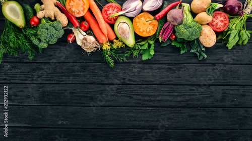 Fototapeta Naklejka Na Ścianę i Meble -  Healthy food. Vegetables and fruits. On a black wooden background. Top view. Copy space.