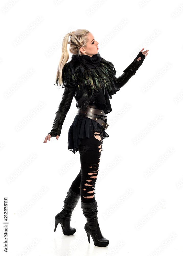 full length portrait of blonde girl wearing torn black feather costume. standing pose, isolated on white background. full length portrait of blonde girl wearing torn black feather costume. standing pose, isolated on white background.