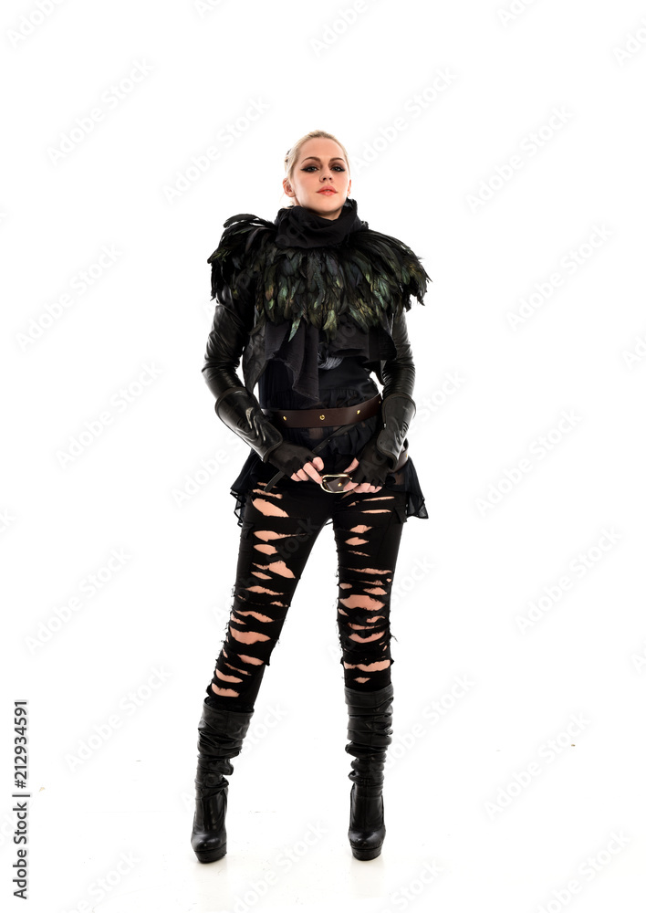 full length portrait of blonde girl wearing torn black feather costume. standing pose, isolated on white background.