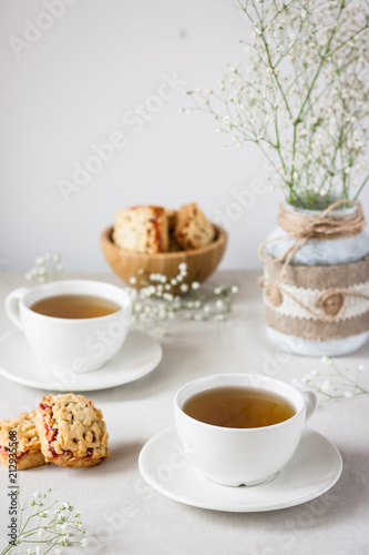 tea served in white cup on white table. Hot drink for winter. Selective focus