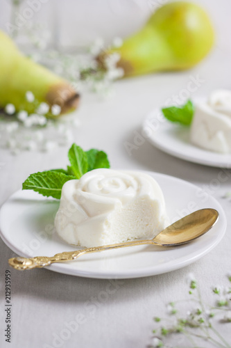 Panna Cotta, traditional sweet Italian dessert, with mint and pear