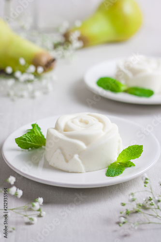 Panna Cotta, traditional sweet Italian dessert, with mint and pear