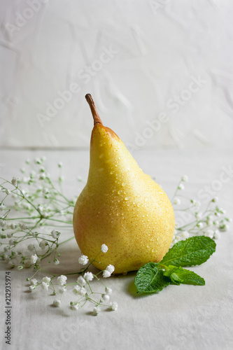 Fresh and juicy pear on the white table