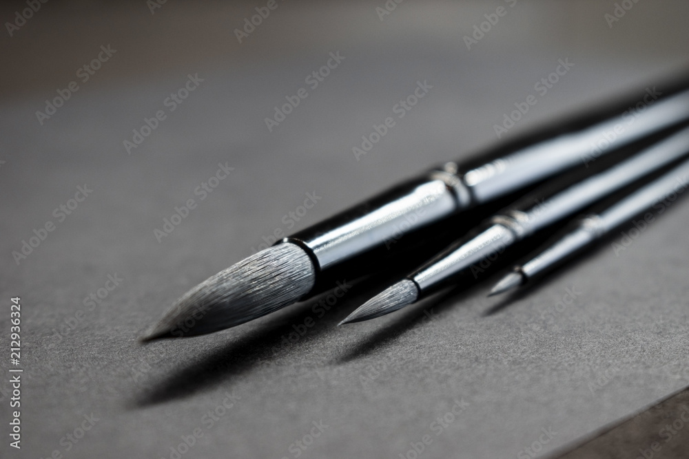 set of Style black artistic brushes on dark background. Minimalistic concept set of Style black artistic brushes on dark background. Minimalistic concept