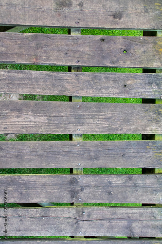 Wooden slats suspended over grass
