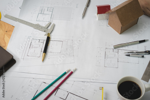 Architectural plans work space top view. Architectural project, blueprints,pencil and divider compass on wooden desk table.Construction background.Engineering tools. Copy space.Architectural Concept