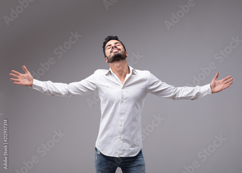 Man showing relieved gesture with spread arms photo