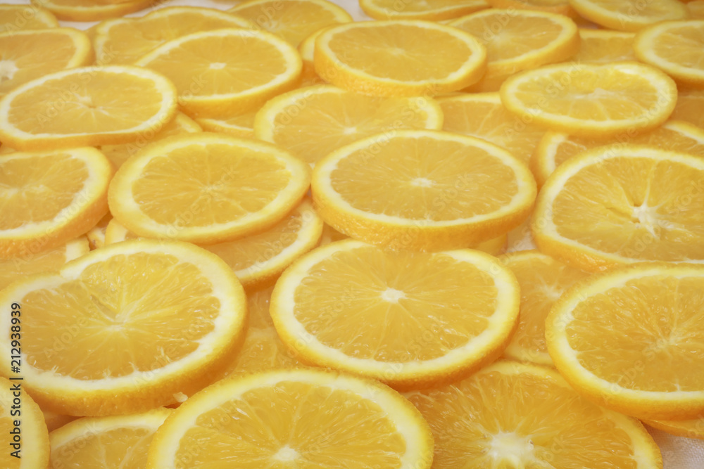 Round slices of oranges on the horizontal surface, background Round slices of oranges on the horizontal surface, background