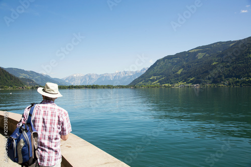 Tourist enjoying the view over Zell am See lake in Austria.