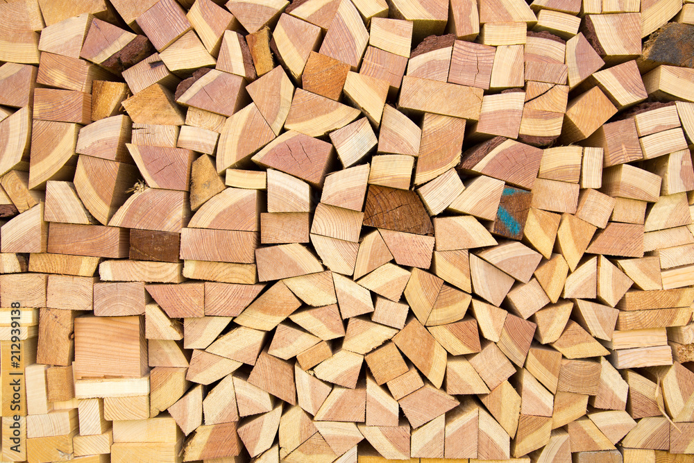 Neatly stacked full frame wood beams and branches background texture patterns. Neatly stacked full frame wood beams and branches background texture patterns.