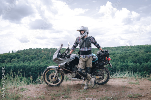 Adventure motorcycle, Motorcyclist gear, A motorbike driver looks, concept of active lifestyle, enduro travel road trip © Sergey