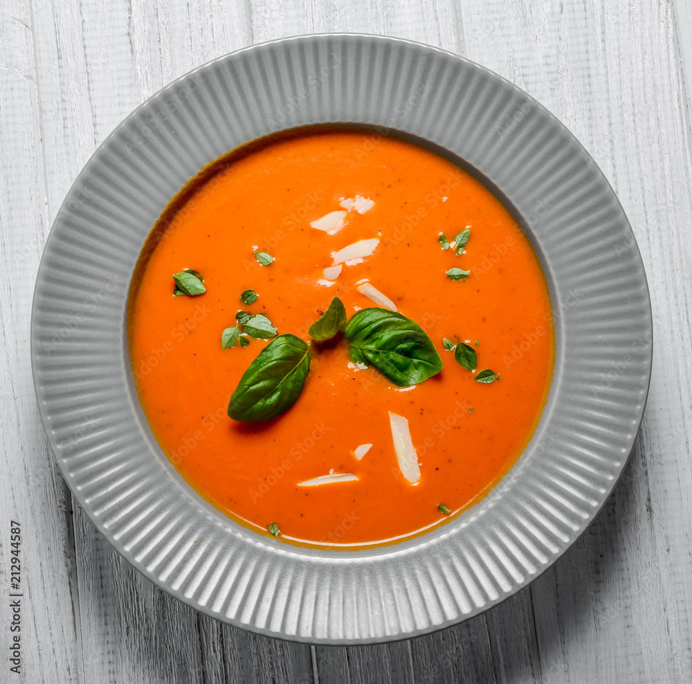 Tomato soup on wooden table Tomato soup on wooden table