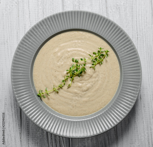 Mushroom soup with parsley on rustic gray background