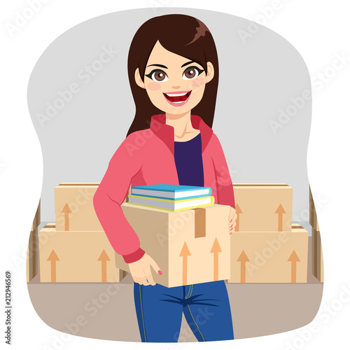 Beautiful young student woman preparing cardboard boxes moving to college dorm