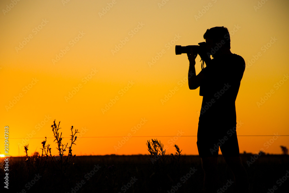 Photographer portrayed at sunset