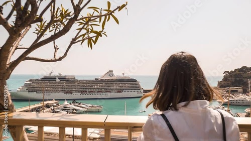 Young woman walking to a viewpoint of Monaco Hercules yacht cruise ship reveal photo