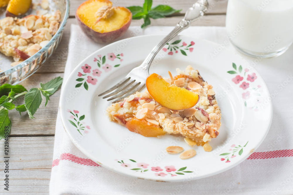 Peach crumble on a wooden and textile background Peach crumble on a wooden and textile background