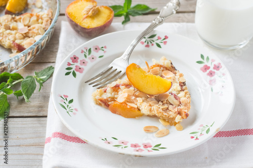 Peach crumble on a wooden and textile background