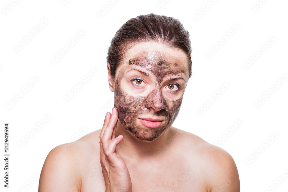 Skincare concept portrait of a female brunette with black charcoal film mask applied to her face Skincare concept portrait of a female brunette with black charcoal film mask applied to her face
