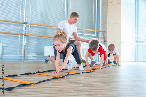 Happy sporty children in gym. Kids exercises