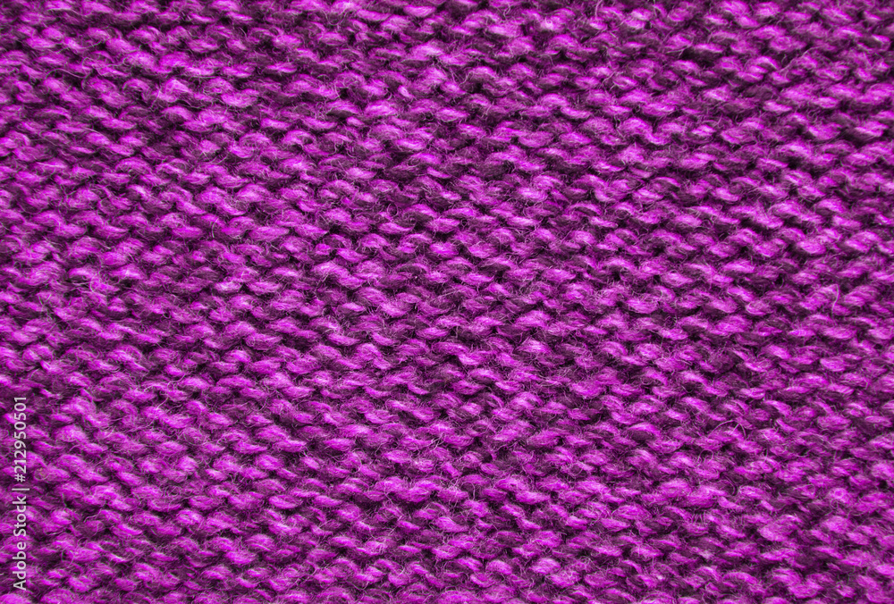 The texture of a knitted woolen fabric pink.