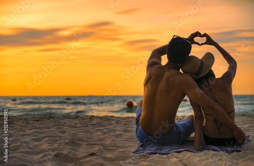 Happy couple asian in love having romantic tender moments at sunset on the beach