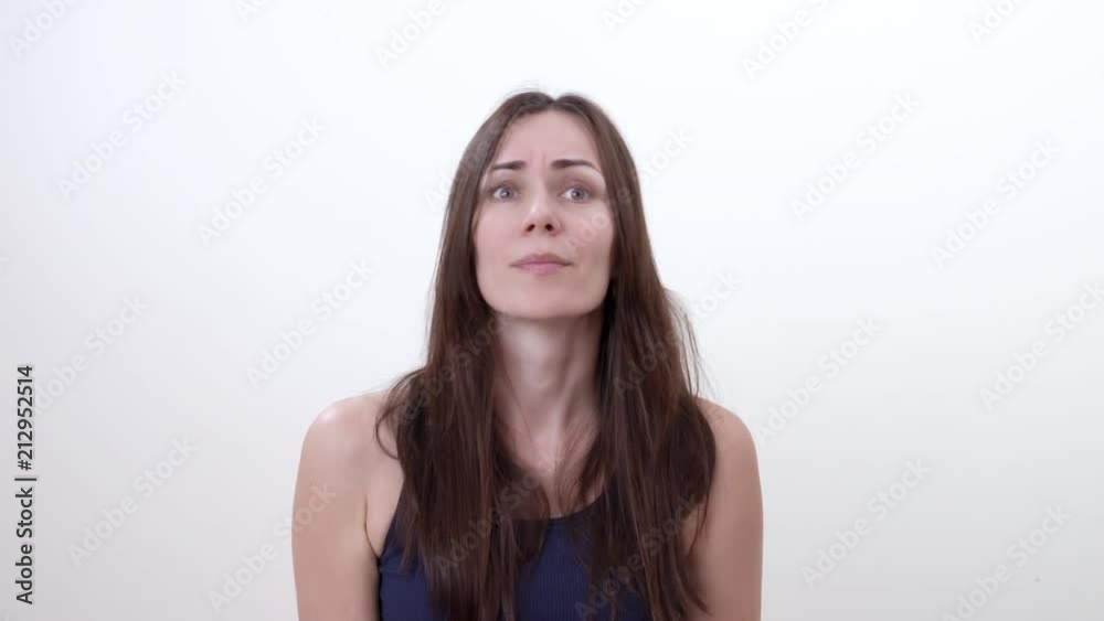 Portrait of instructive woman. Finger up. Frown. Instructive gesture. Isolated on the white background.