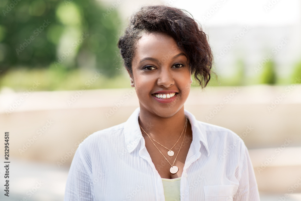 people, race, ethnicity and portrait concept - happy african american young woman outdoors in summer people, race, ethnicity and portrait concept - happy african american young woman outdoors in summer