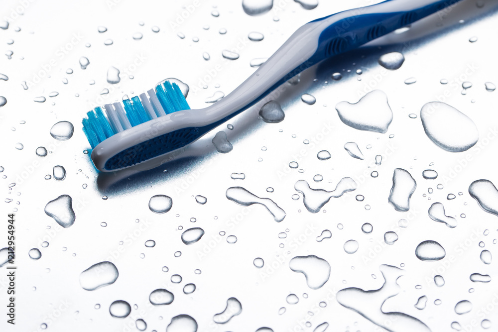 Blue toothbrush on a gray background closeup Blue toothbrush on a gray background closeup