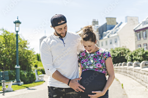Pregnant couple portrait outside in the neighborhood