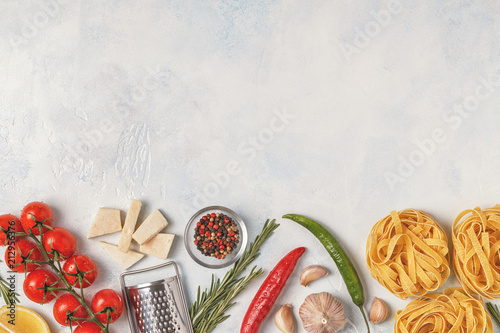 Fototapeta Naklejka Na Ścianę i Meble -  Italian food background with pasta, spices and vegetables.