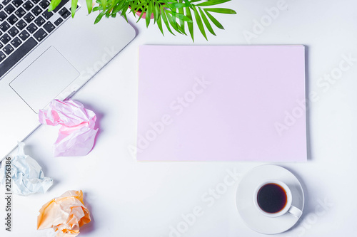 laptop sheets of paper, crumpled sheets of paper on a white background top view