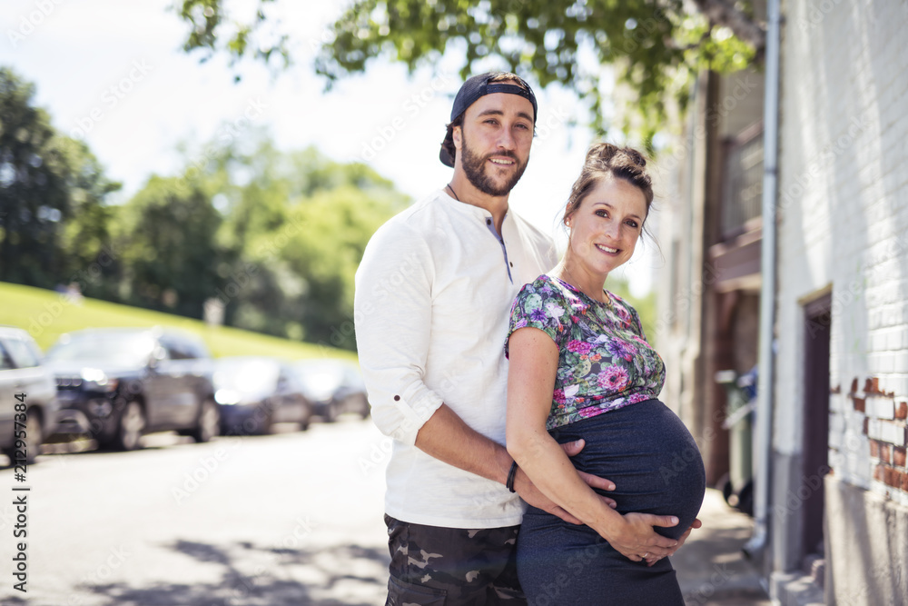 Pregnant couple portrait outside in the neighborhood
