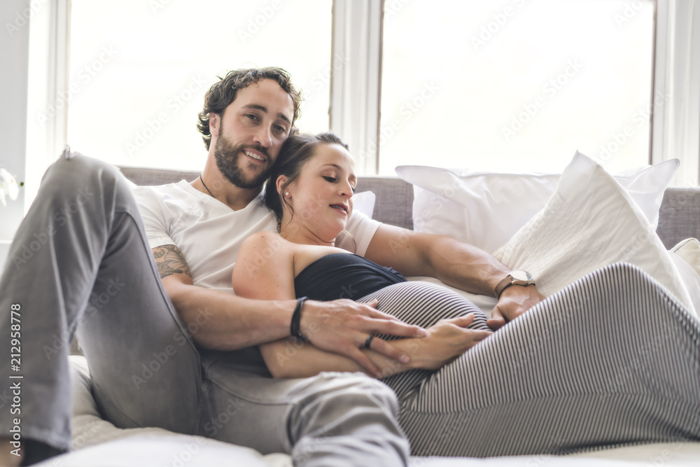 Man with pregnant woman in bed at home having great time Man with pregnant woman in bed at home having great time