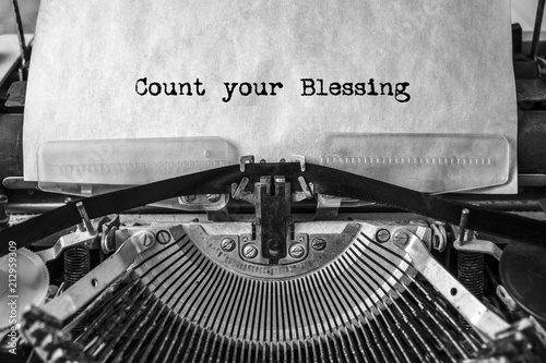 Count your Blessing, the text is typed in a vintage typewriter. Old paper, close-up.