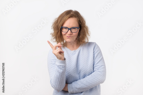 Girl expresses disdain to her boss. Portrait of displeased beautiful caucasian woman.