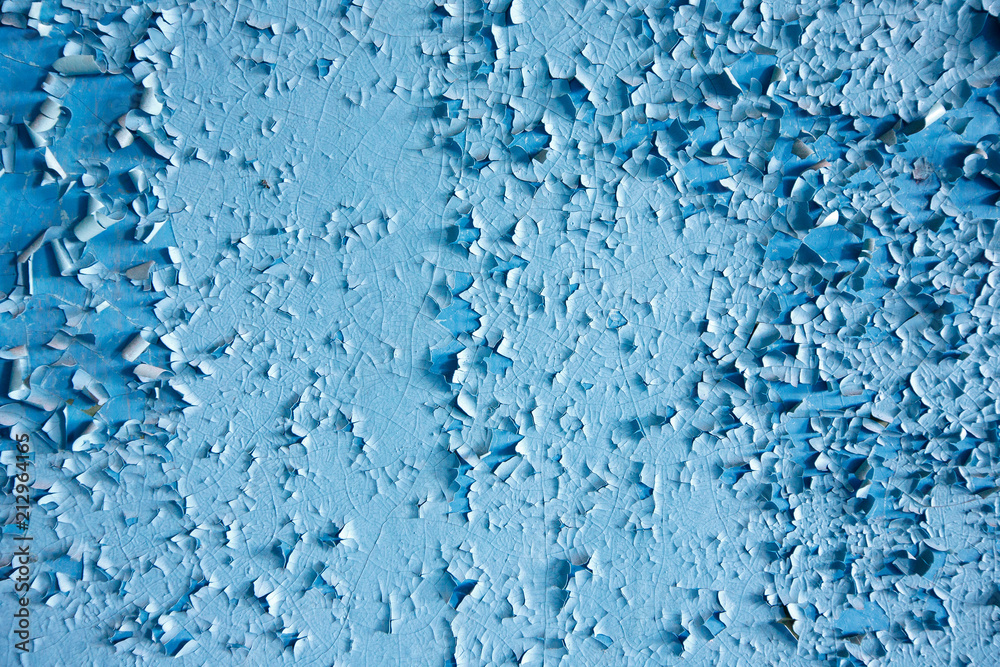 Texture paint old, peeled off pieces from wall, blue background. Concept solar radiation, corrosion.