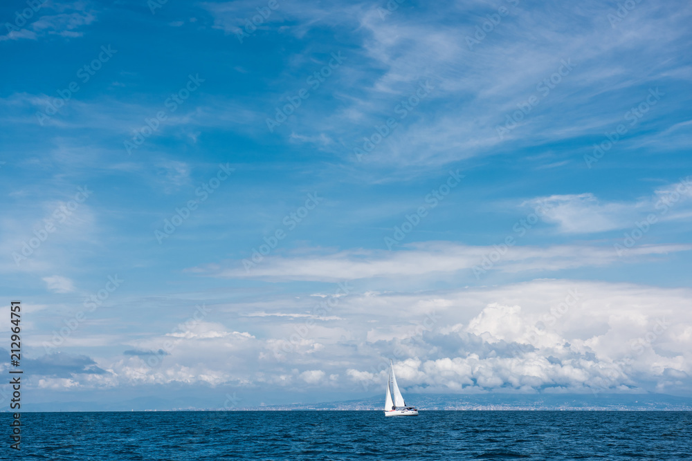 Fototapeta premium Yacht with white sails in the open sea